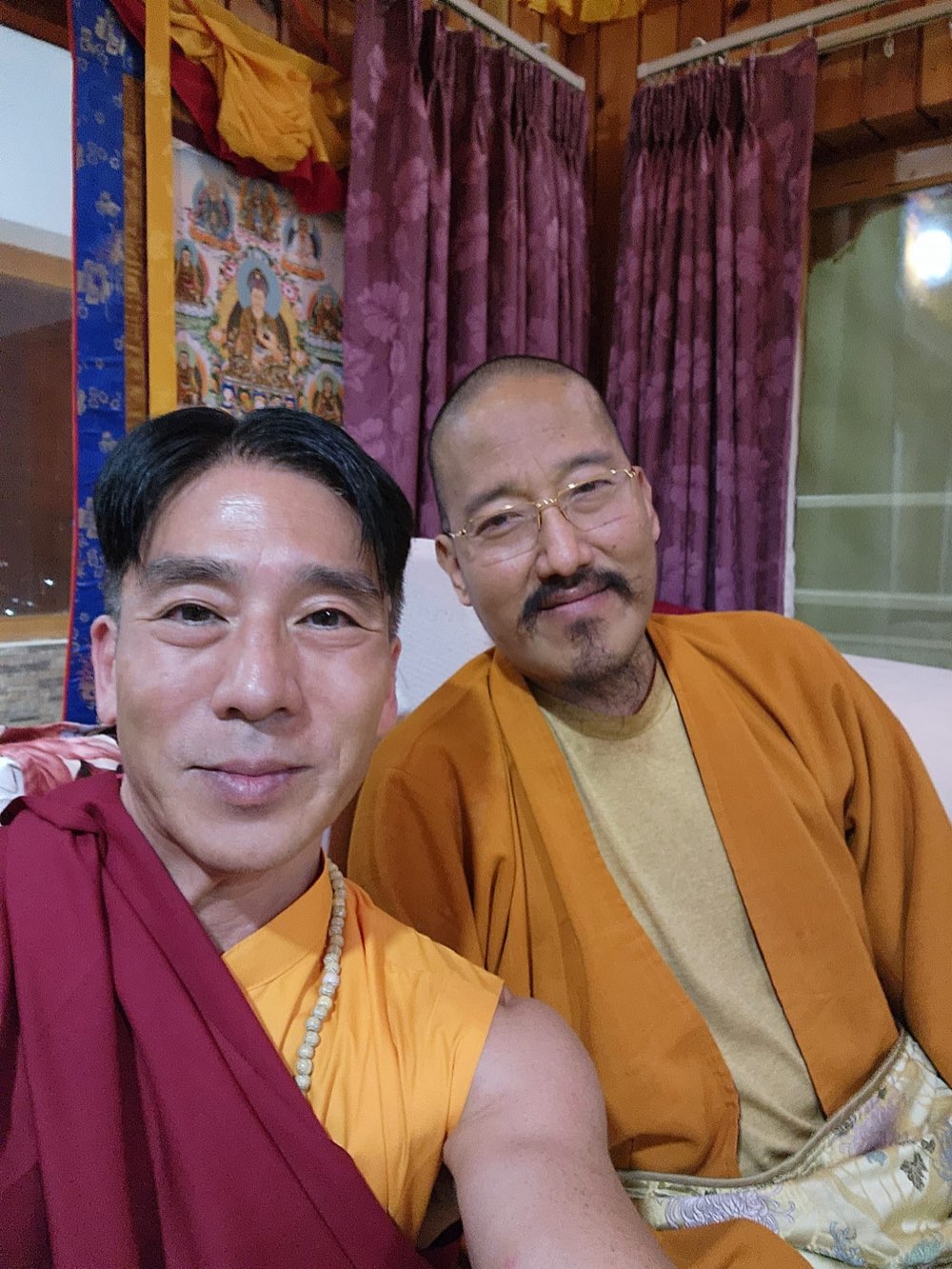 Alex with the late Guru Khyentse Ozer Rinpoche, both in Vajrayana Buddhist robes